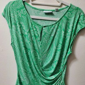 New York & Company green women's sweater with white prints and crossover design.